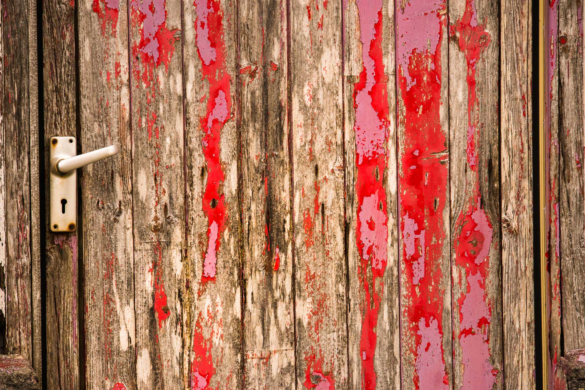 pink and red peeling paint door